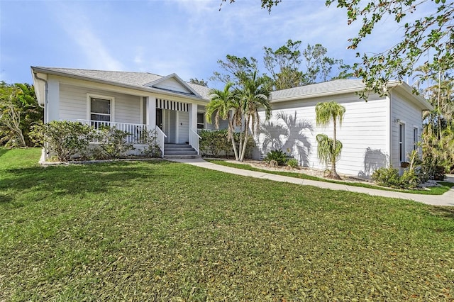 ranch-style house with covered porch, a front yard, and a garage