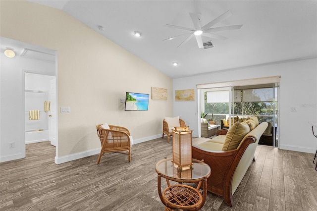 living room with ceiling fan, lofted ceiling, and hardwood / wood-style flooring