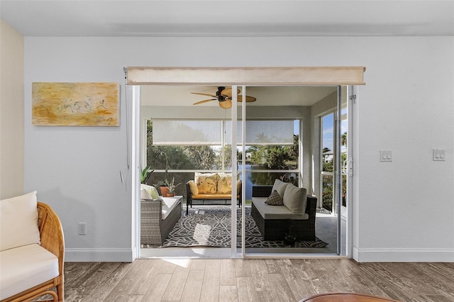 doorway featuring ceiling fan and hardwood / wood-style flooring