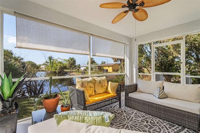 sunroom / solarium with a water view and ceiling fan