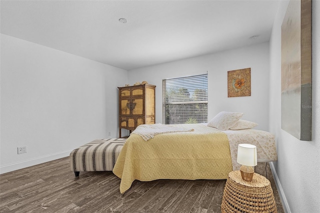 bedroom with dark hardwood / wood-style flooring