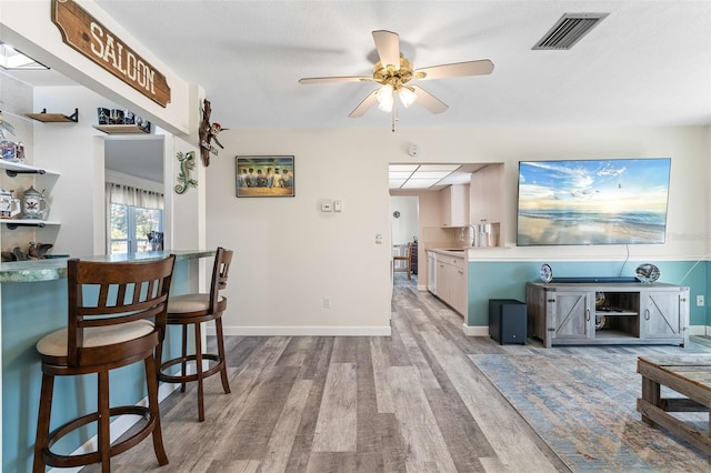 interior space featuring ceiling fan, light hardwood / wood-style flooring, a textured ceiling, and sink