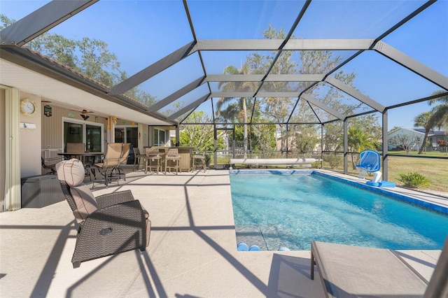 view of pool with an outdoor bar, a lanai, and a patio area