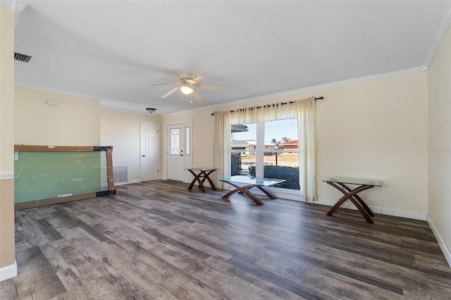 empty room featuring dark hardwood / wood-style floors, ceiling fan, and ornamental molding