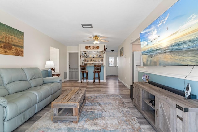 living room featuring dark hardwood / wood-style floors and ceiling fan