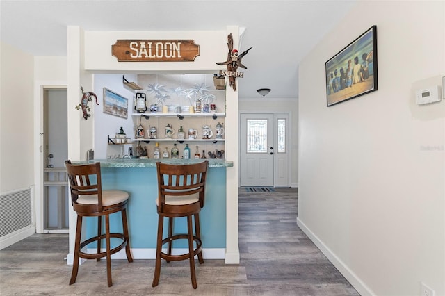 bar with dark hardwood / wood-style floors