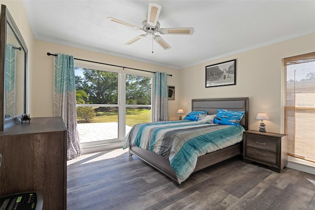 bedroom featuring ceiling fan, dark hardwood / wood-style floors, and crown molding