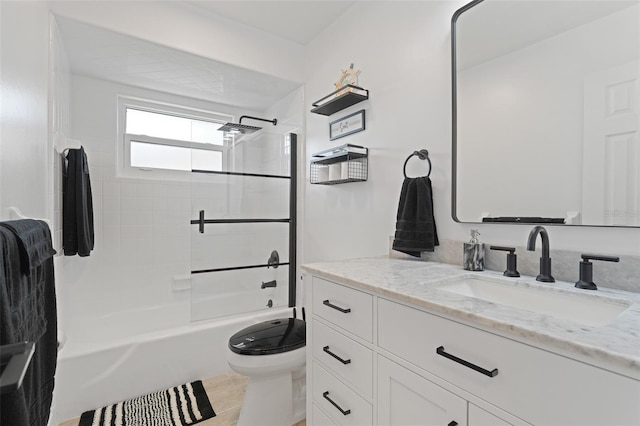 full bathroom with toilet, vanity, and tiled shower / bath combo