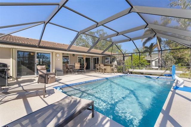 view of swimming pool with a lanai, a patio area, pool water feature, and an outdoor bar