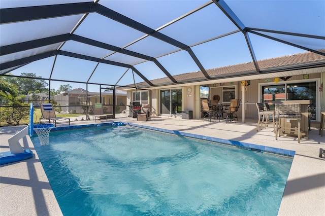 view of pool featuring pool water feature, ceiling fan, a lanai, a patio area, and a bar