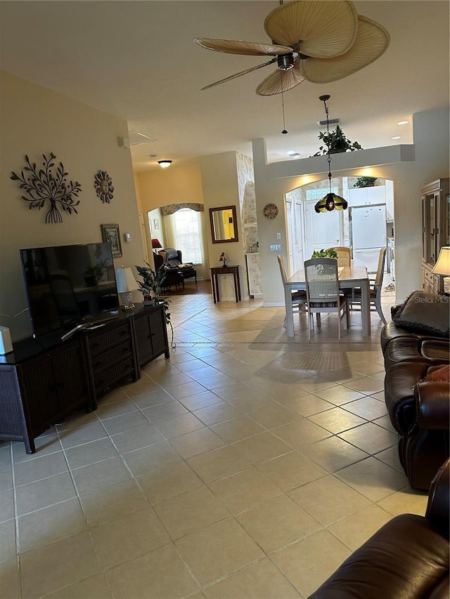 living area featuring light tile patterned floors and ceiling fan