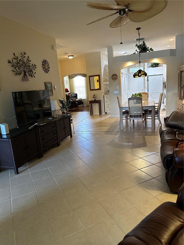 living room with ceiling fan and light tile patterned floors