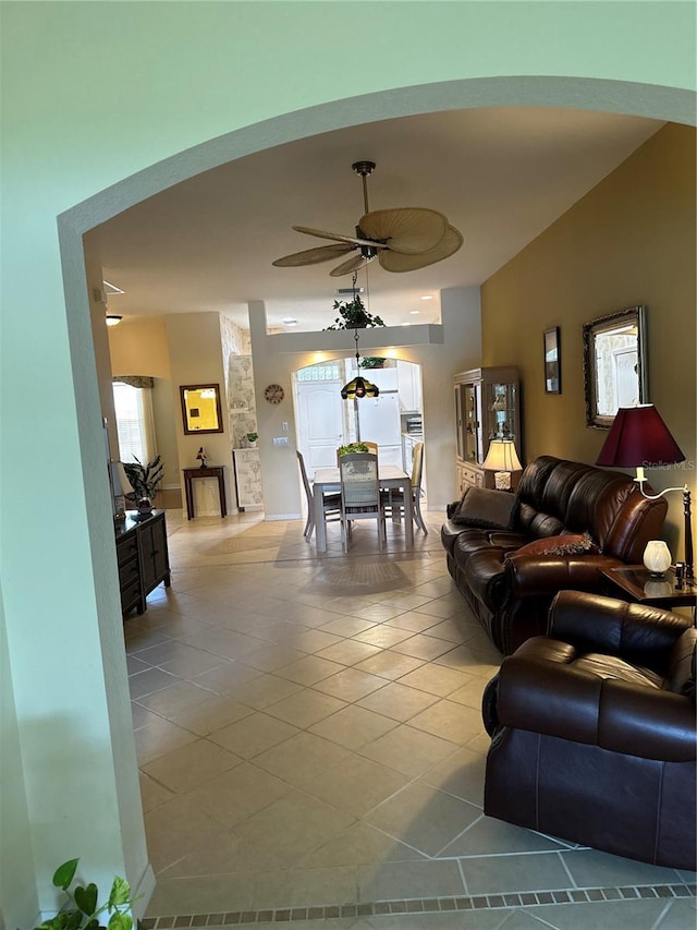 living area featuring light tile patterned floors and a ceiling fan