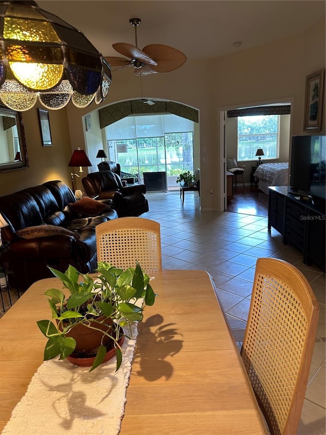 living room with tile patterned flooring and a ceiling fan