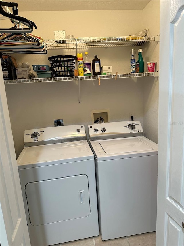 laundry area with light tile patterned floors and independent washer and dryer