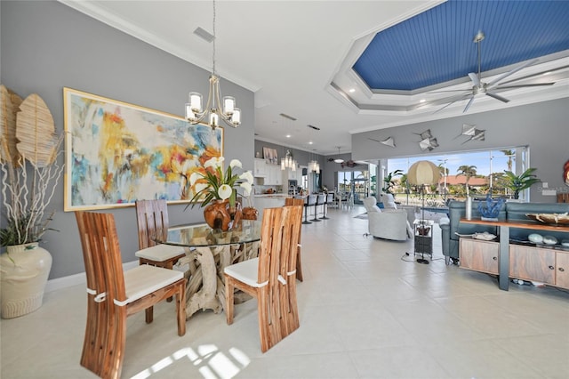 dining space with ceiling fan with notable chandelier, a raised ceiling, and crown molding