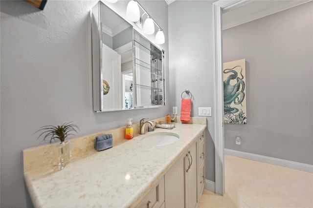 bathroom featuring vanity, tile patterned floors, and ornamental molding