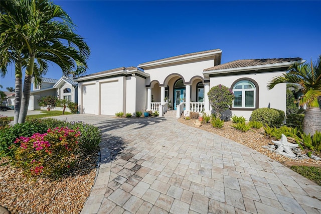 view of front of home with a porch and a garage