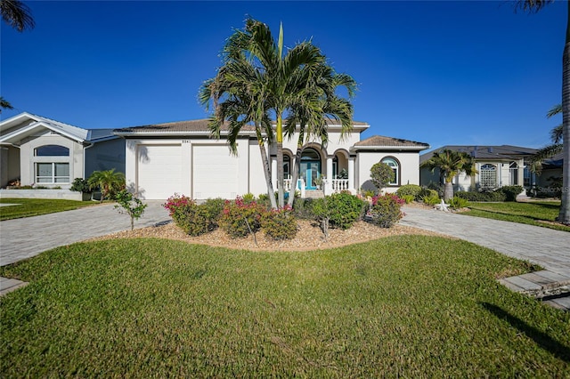 view of front of house with a front yard and a garage