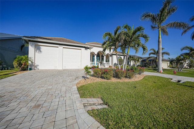 view of front of home with a front yard and a garage