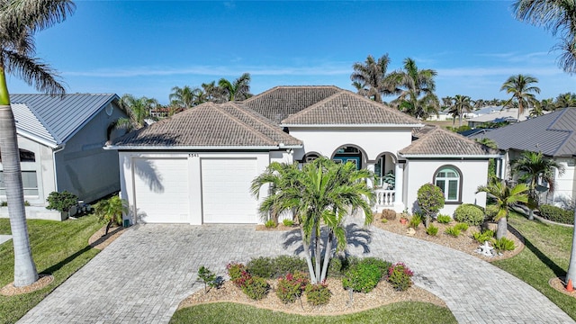 view of front facade with a garage and a front lawn