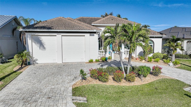 view of front of house featuring a front yard and a garage