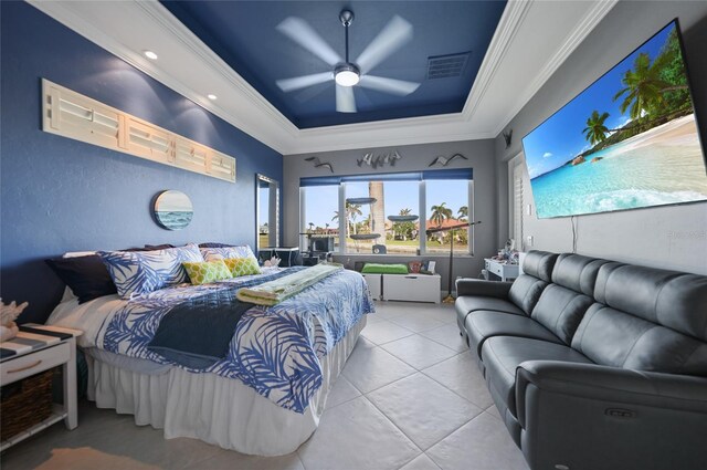 bedroom with a tray ceiling, visible vents, ornamental molding, ceiling fan, and tile patterned flooring