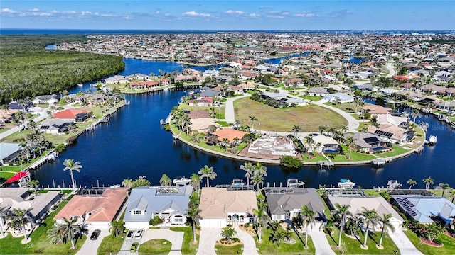 drone / aerial view featuring a water view and a residential view