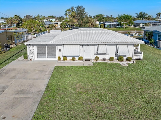 view of front of house featuring a garage, a front lawn, and central air condition unit