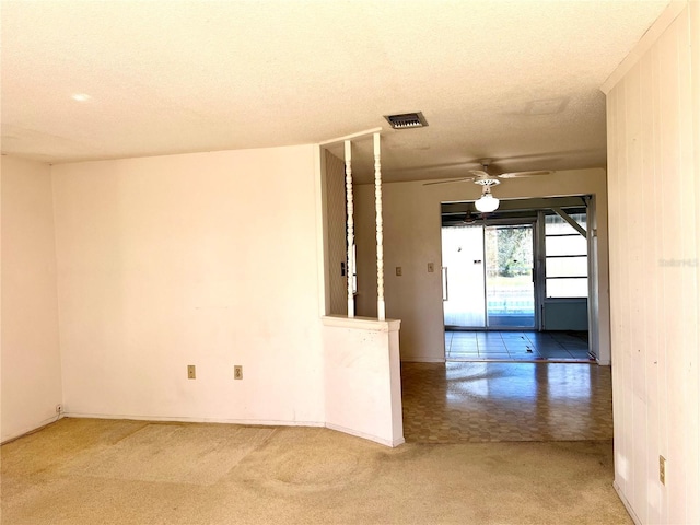 empty room with a textured ceiling and ceiling fan