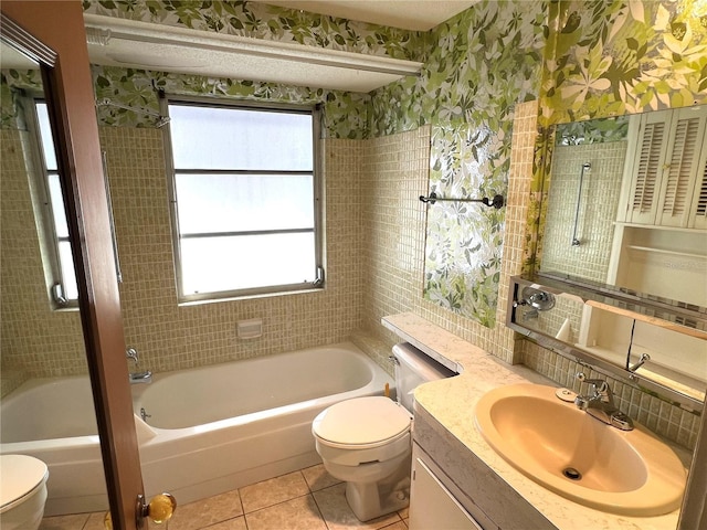 bathroom featuring toilet, a healthy amount of sunlight, vanity, and tile patterned floors