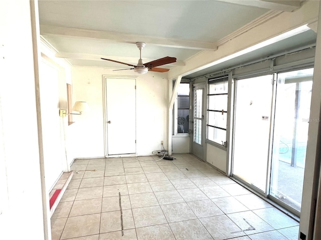 unfurnished room with ceiling fan, plenty of natural light, light tile patterned floors, and beam ceiling