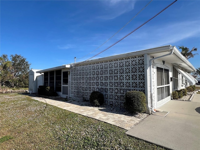 view of side of property with a lawn and a garage