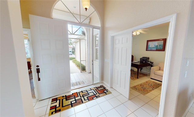 tiled entryway featuring ceiling fan