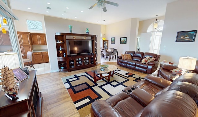 living room featuring ceiling fan and light hardwood / wood-style flooring