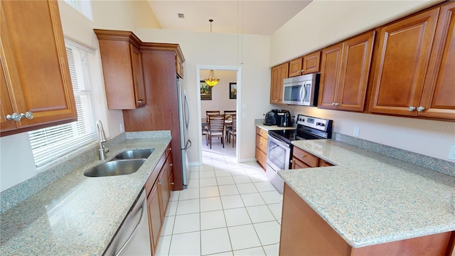 kitchen with a healthy amount of sunlight, light stone counters, and stainless steel appliances