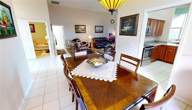 dining space featuring light tile patterned floors