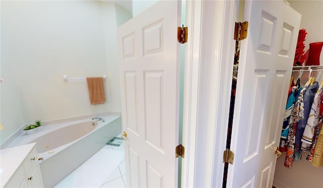 bathroom featuring tile patterned flooring and a tub to relax in