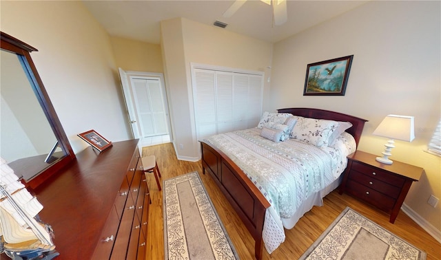 bedroom featuring ceiling fan, a closet, and light hardwood / wood-style floors