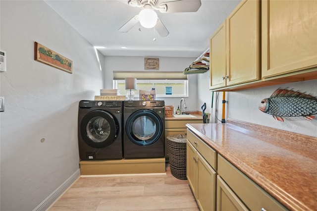 laundry room with ceiling fan, sink, cabinets, separate washer and dryer, and light hardwood / wood-style flooring