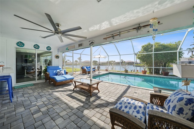 view of swimming pool with glass enclosure, a water view, an outdoor living space, and a patio