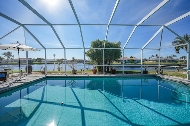 view of swimming pool with a lanai, a water view, and a patio