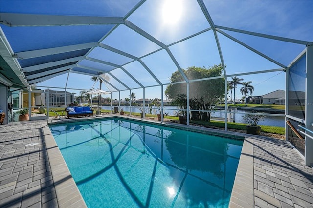 view of swimming pool with a water view, a patio area, and a lanai