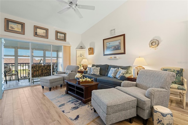 living room featuring ceiling fan, light hardwood / wood-style flooring, and high vaulted ceiling