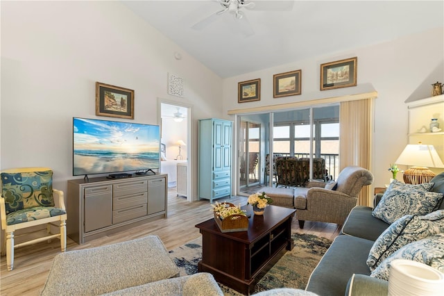 living room featuring ceiling fan, light hardwood / wood-style floors, and high vaulted ceiling