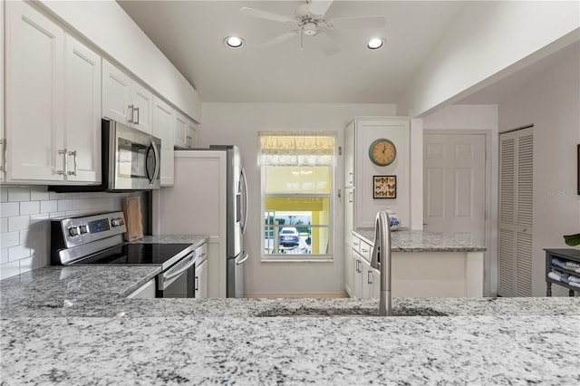 4000 Bal Harbor Blvd Unit 126, Punta Gorda, FL 33950 - kitchen featuring stainless steel appliances, backsplash, light stone counters, ceiling fan, and white cabinets