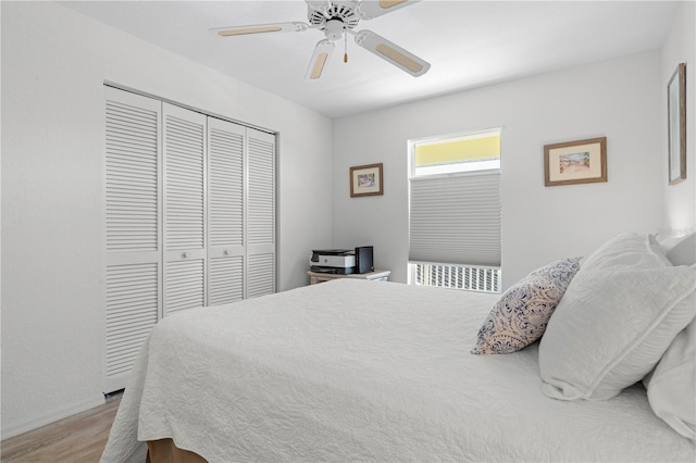 bedroom with ceiling fan, a closet, and light hardwood / wood-style floors