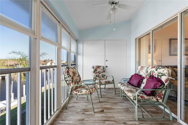 sunroom featuring ceiling fan, plenty of natural light, and lofted ceiling