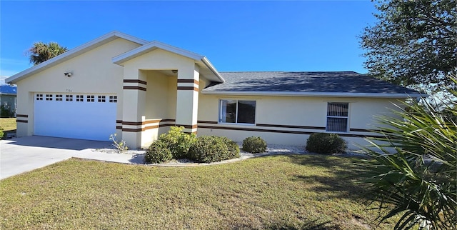 view of front of property featuring a garage and a front lawn