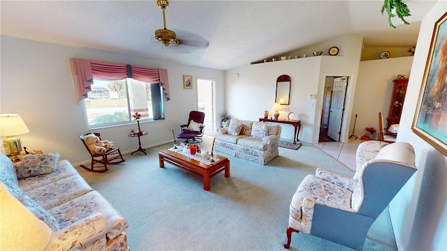 living room with ceiling fan, light carpet, and vaulted ceiling